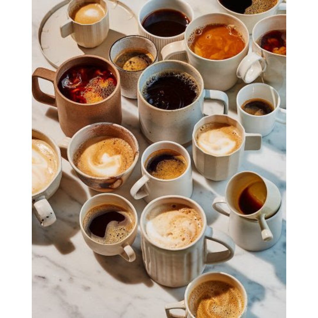 a table topped with lots of cups of coffee