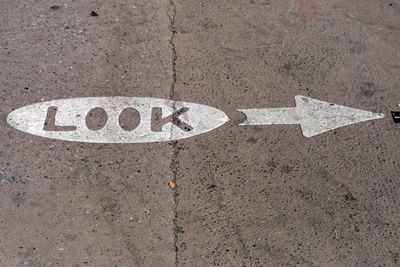 an arrow painted on the ground with the word look painted on it