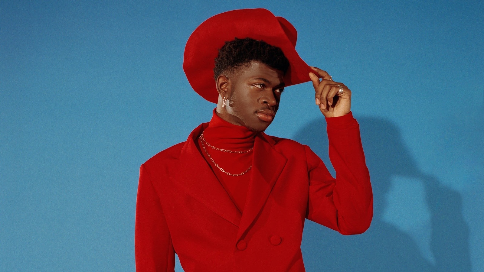 a woman in a red suit and red hat