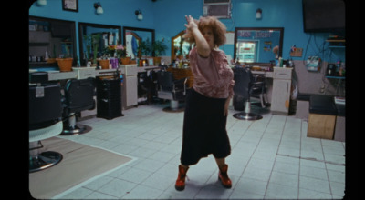 a woman standing in a room with a hair dryer