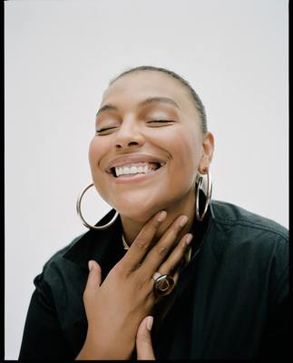 a woman smiling with her hands on her face