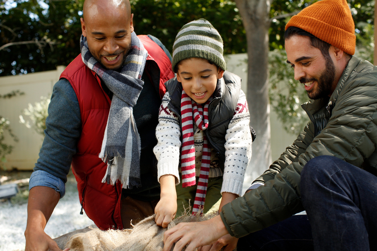 a man and two children petting a horse