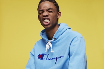 a man in a blue champion hoodie with his mouth open