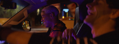 a man sitting in the passenger seat of a car