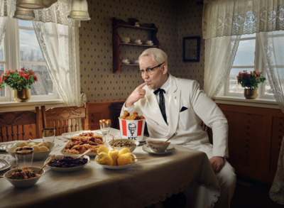 a man sitting at a table with a lot of food