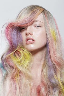 a woman with multicolored hair is posing for a picture