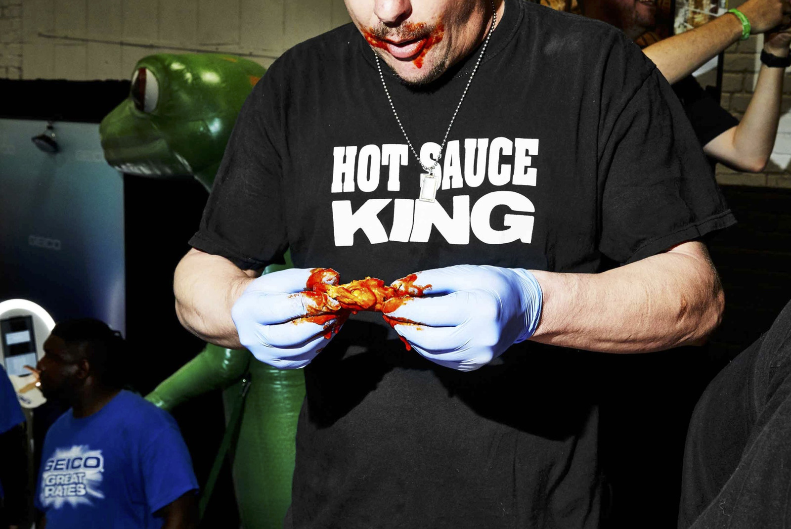 a man wearing a hot sauce king t - shirt