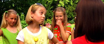 a group of young girls standing next to each other