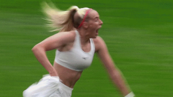 a woman in a white top is playing tennis