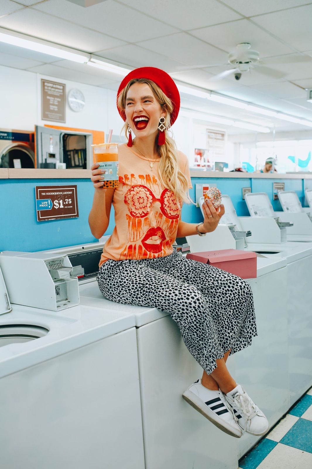 a woman sitting on top of a washing machine