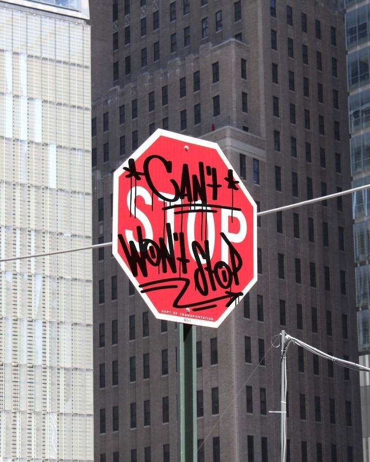 a stop sign has been vandalized with graffiti