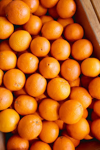 a box full of oranges sitting on a table