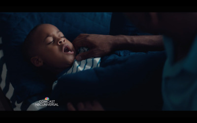 a baby is being fed a bottle by a man