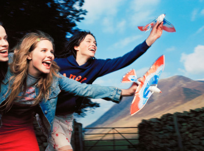 a group of young women playing a game of frisbee