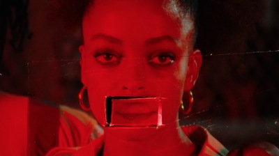 a woman's face is reflected in a mirror