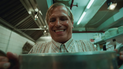 a man is smiling while holding a pot