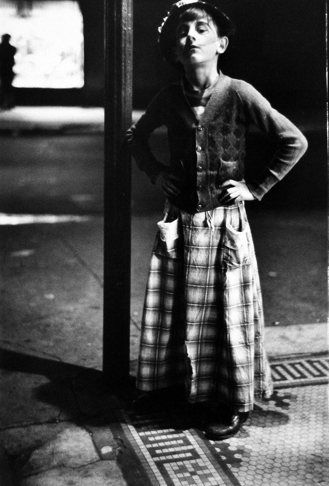 a black and white photo of a person wearing a skirt