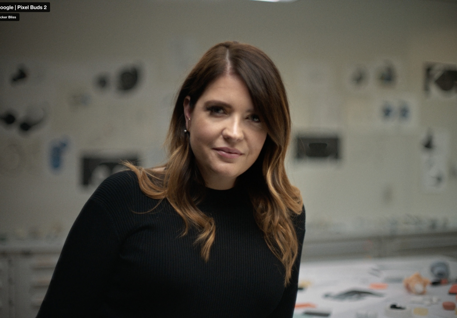 a woman standing in front of a wall covered in magnets