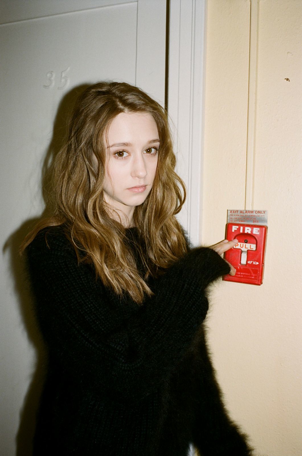 a woman holding a red box with a cross on it