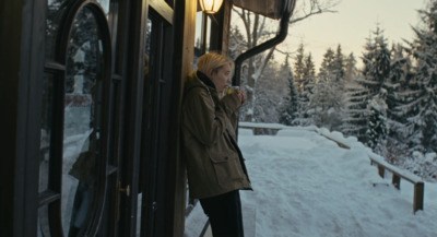 a person standing on a train in the snow