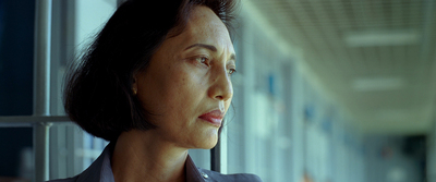 a woman looking out a window at something