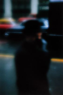 a blurry image of a man walking down a street