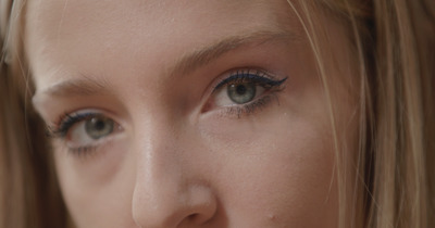 a close up of a woman with blue eyes