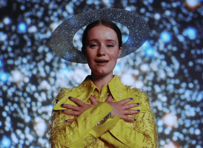 a woman wearing a yellow shirt and a hat