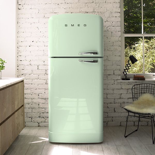 a mint green refrigerator sitting in a kitchen next to a window