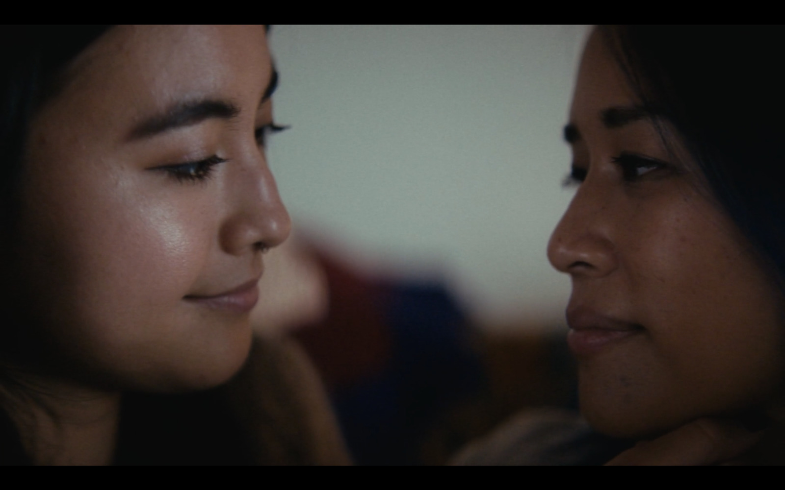 a close up of two women looking at each other