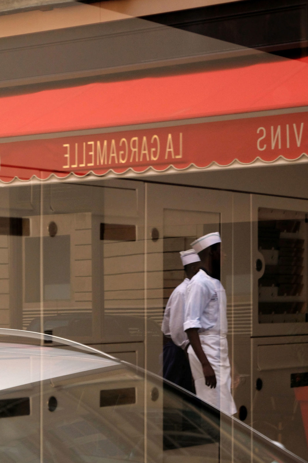 a couple of men walking down a street next to a building