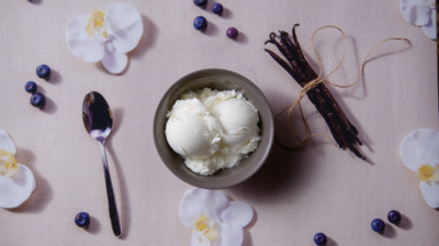 a bowl filled with ice cream next to a spoon