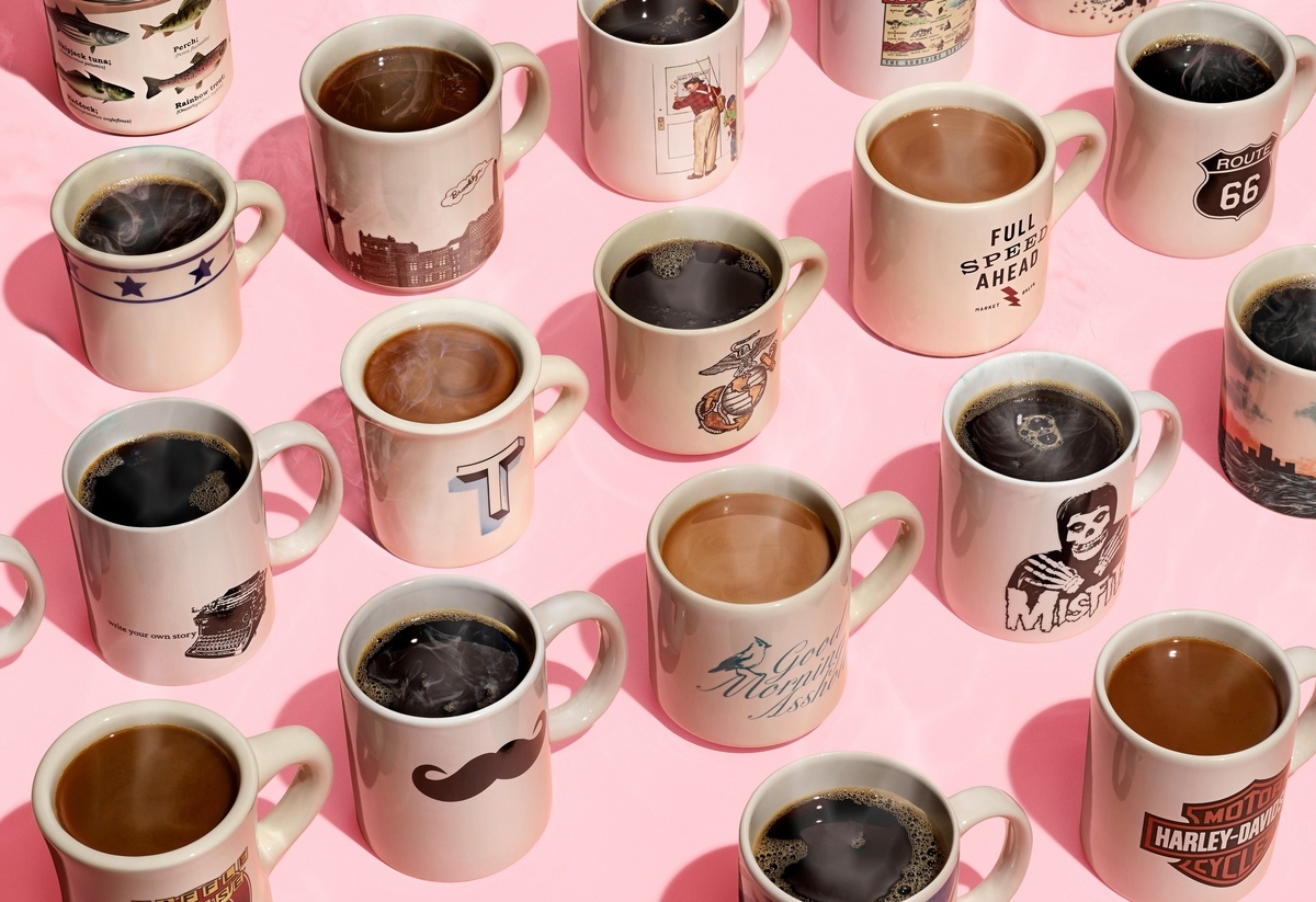 a group of coffee cups sitting on top of a pink table