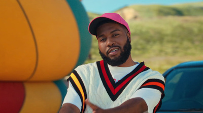 a man in a pink hat standing in front of a large ball