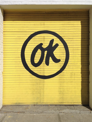 a yellow garage door with the word ok painted on it