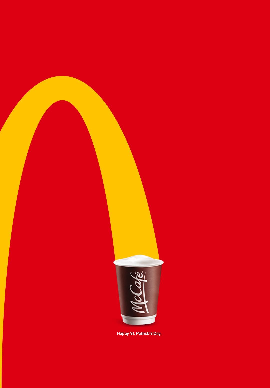 a cup of coffee sitting in front of a mcdonald's logo