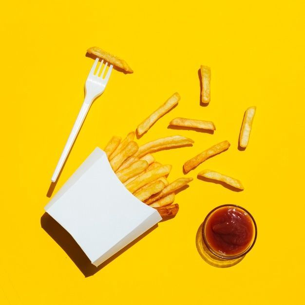 french fries and ketchup on a yellow background