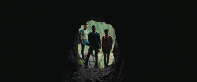 a group of people standing in a cave