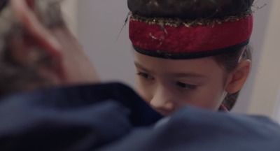 a little girl wearing a red and black hat