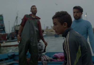 a group of men standing on top of a boat