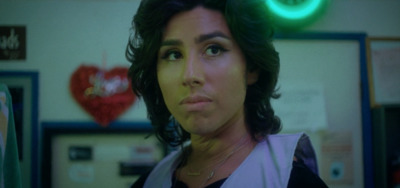 a woman in a room with a green light