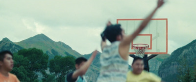 a group of young men playing a game of basketball