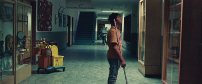 a man standing in a hallway with a cane