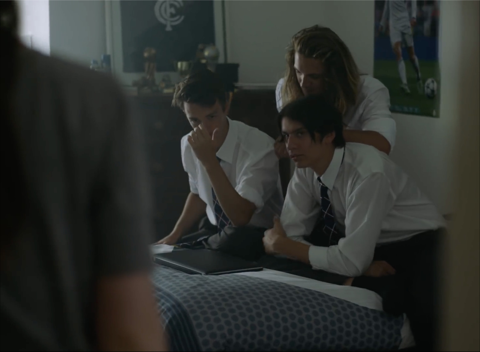 a group of people sitting on top of a bed