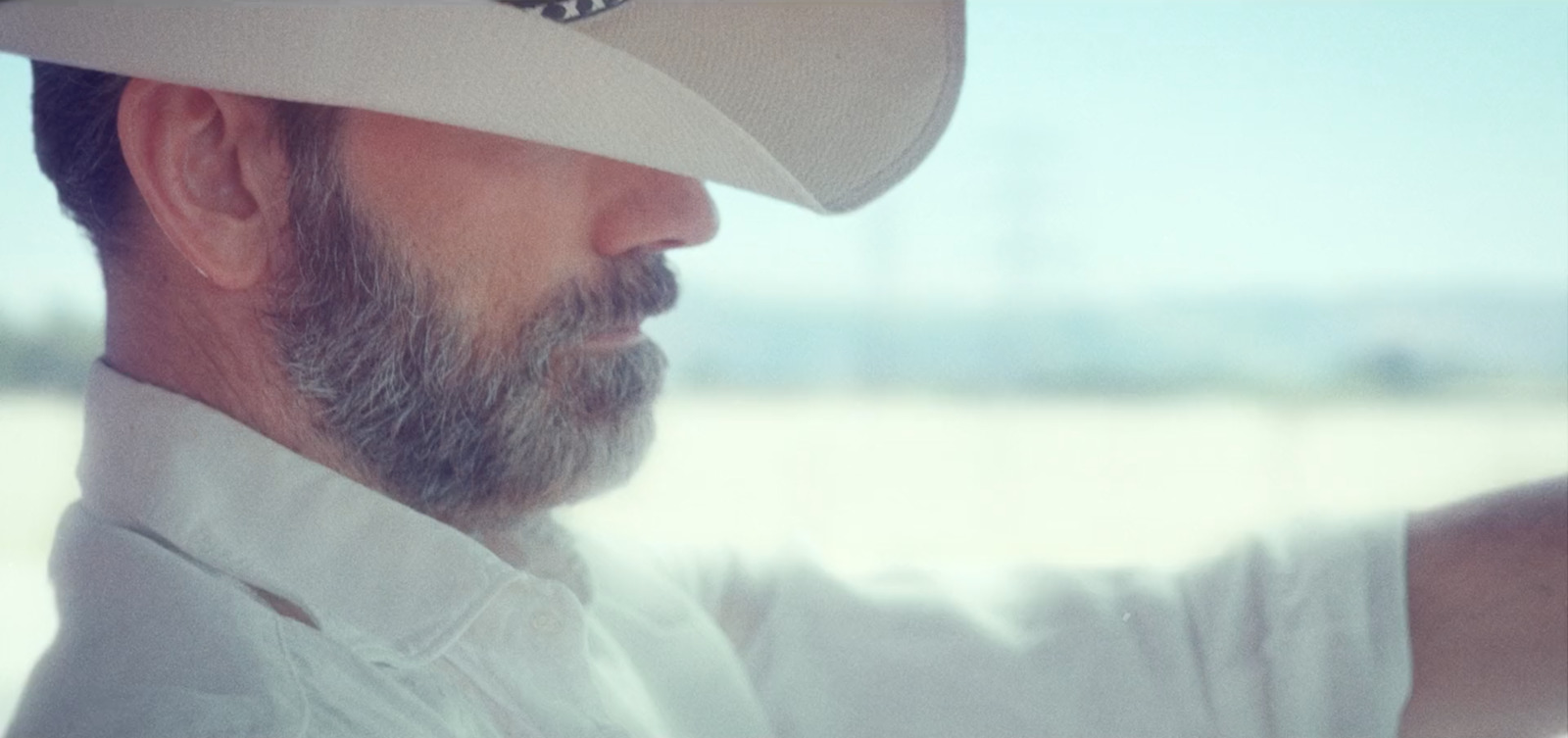 a man wearing a white hat and a white shirt