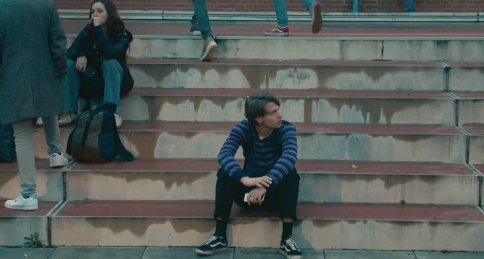 a man sitting on the steps of a stadium