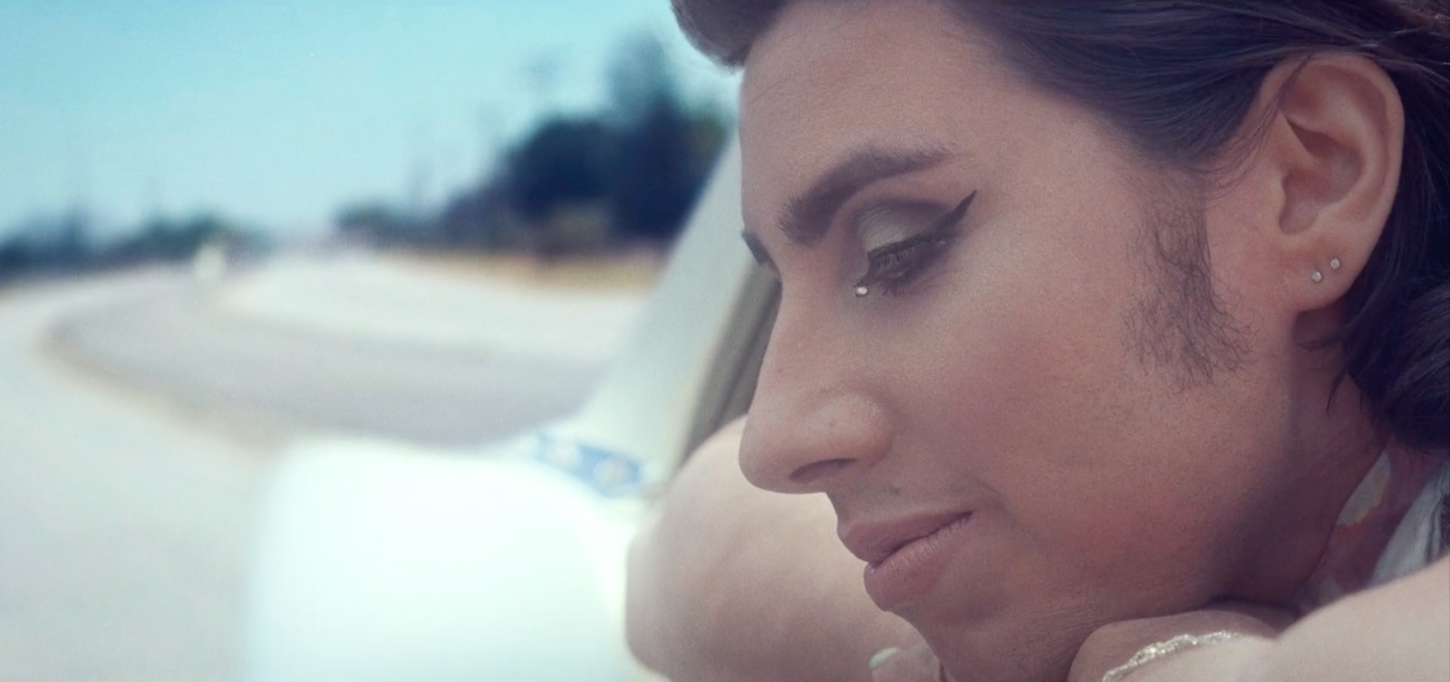 a woman in a car looking at her cell phone