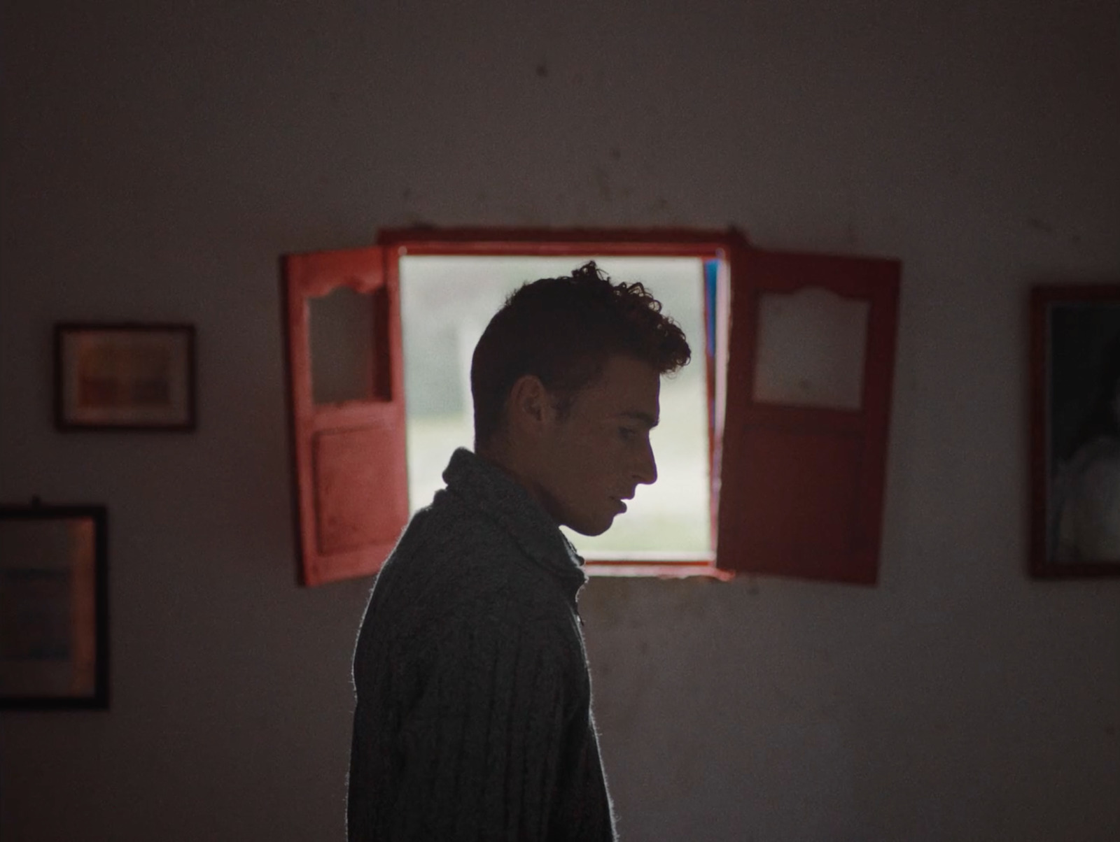 a man standing in front of a window in a room