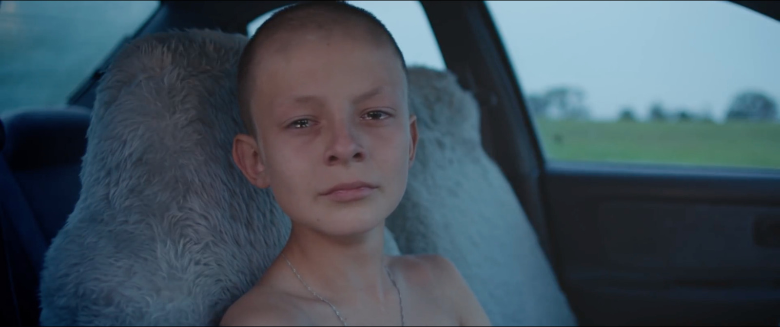 a woman sitting in the back seat of a car