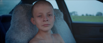 a woman sitting in the back seat of a car